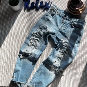 Ripped, blue denim jeans.